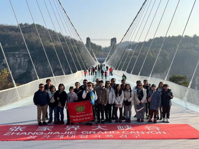 Super Travels tour group on the Zhangjiajie Grand Canyon glass bridge, China