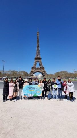Super Travels tour group at the Eiffel Tower, Paris