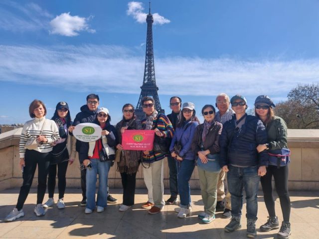Super Travels tour group at the Eiffel Tower, Paris